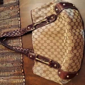 Authentic Gucci braided leather straps monogram handbag.